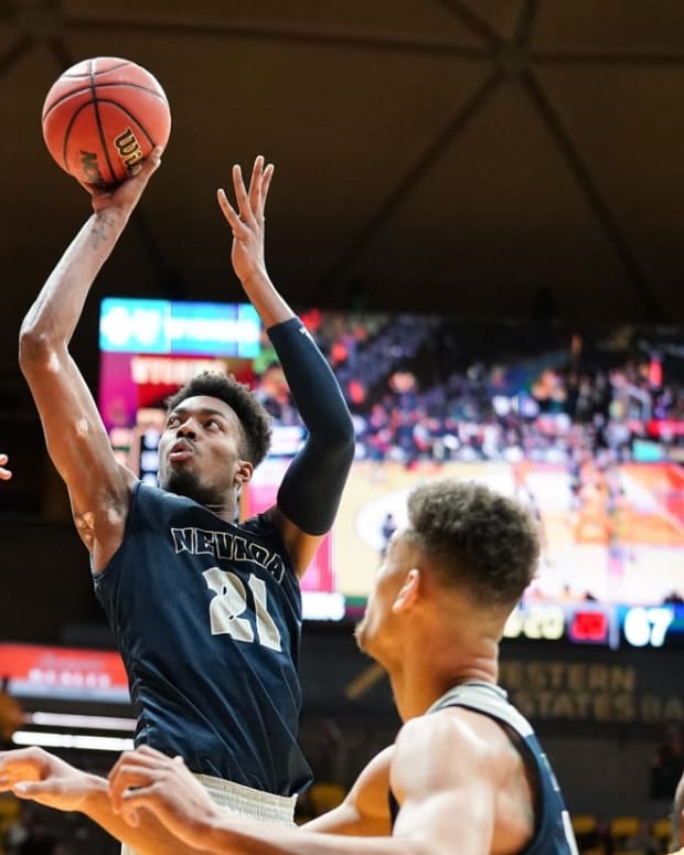 Feb 16, 2019; Laramie, WY, USA; Nevada Wolf Pack forward Jordan Brown (21) shoots against Wyoming Cowboys forward Hunter Thompson (10) during the second half at Arena-Auditorium. Mandatory Credit: Troy Babbitt-USA TODAY Sports

